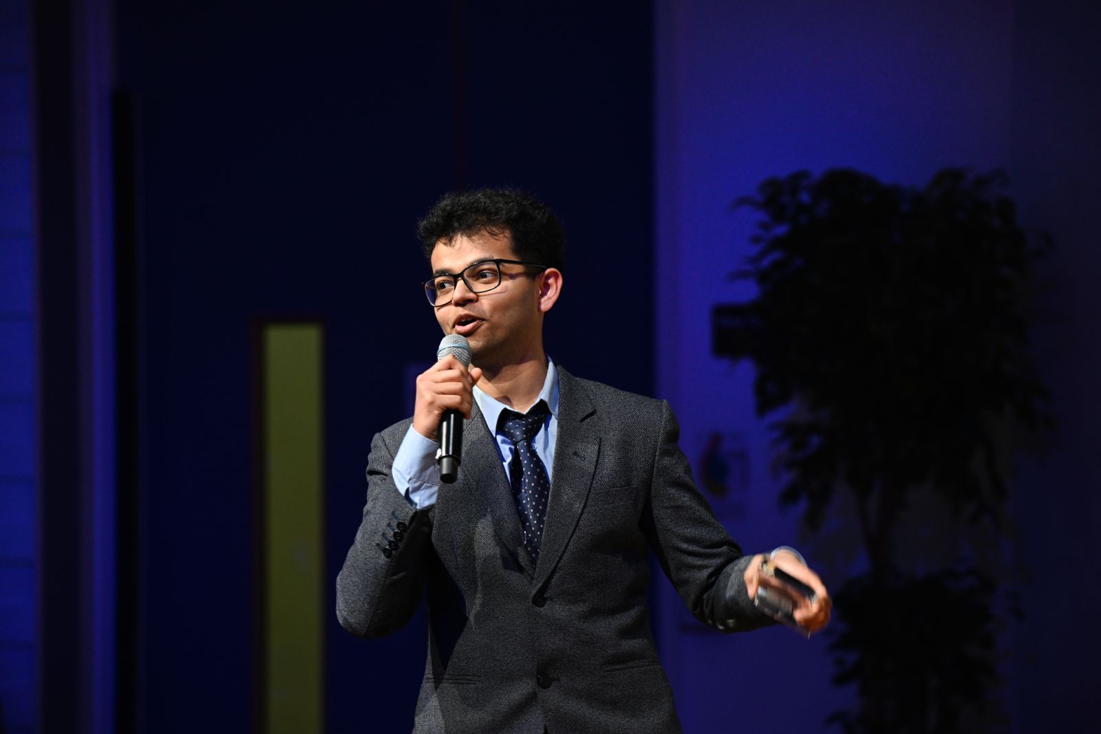 Aman presenting technical work on stage